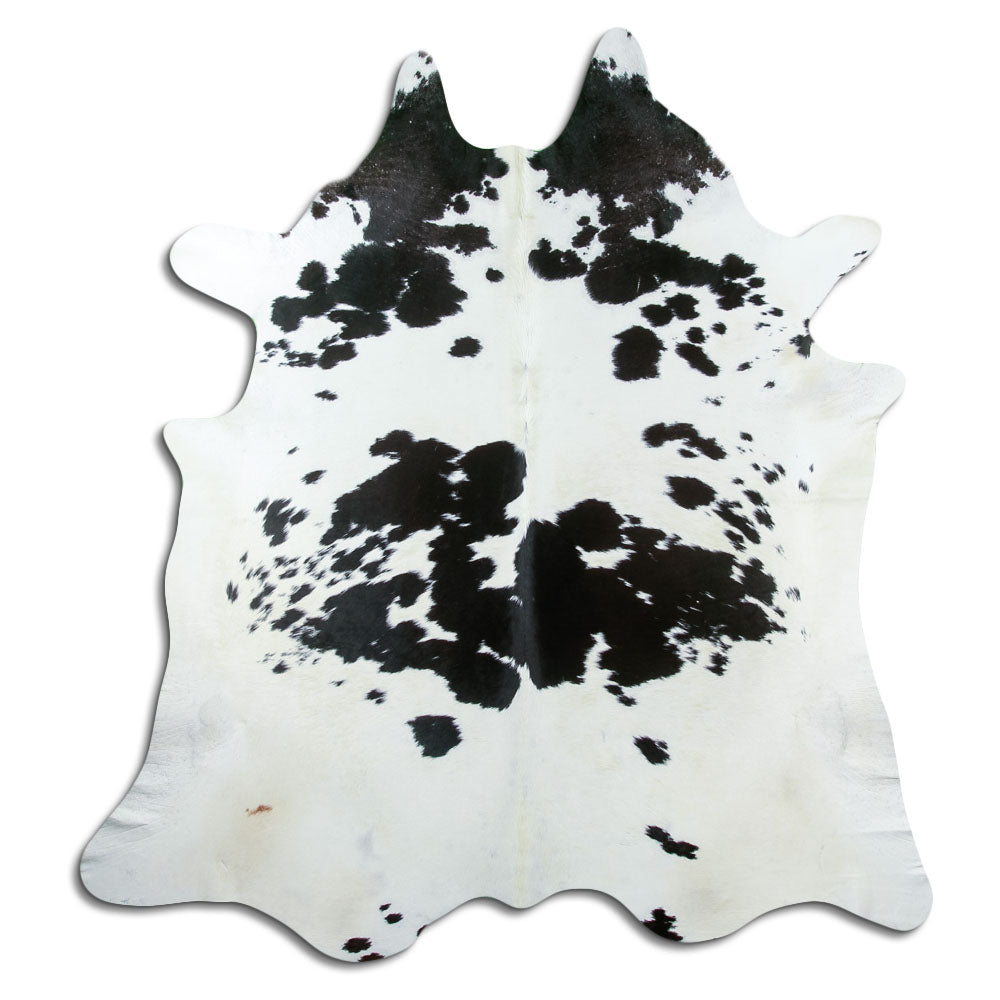 Black and white cowhide rug of about 220 × 200 cm, seen from above: the exact hide you receive