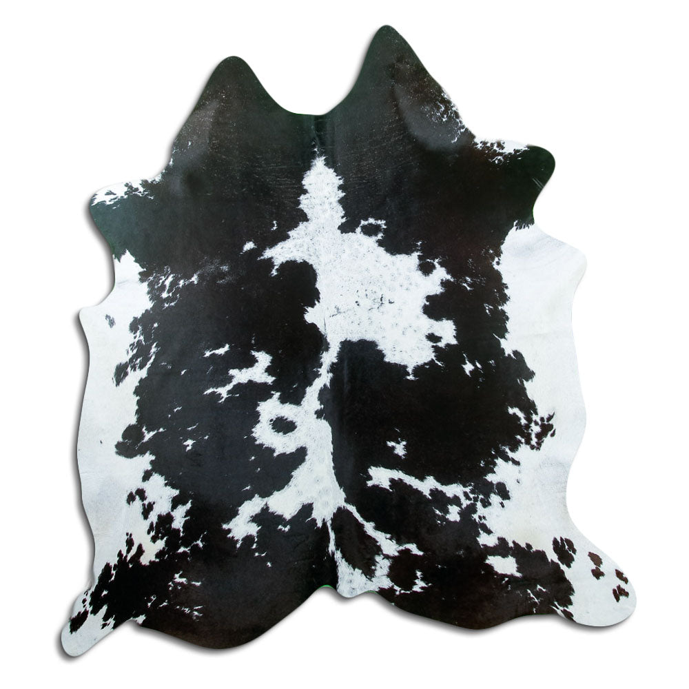 Black and white cowhide rug of about 180 × 170 cm, seen from above: the exact hide you receive