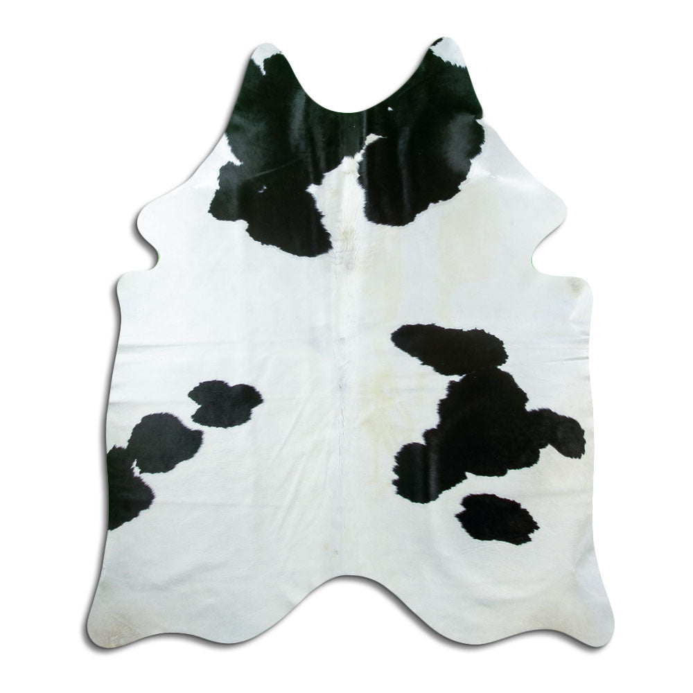 Black and white cowhide rug of about 180 × 150 cm, seen from above: the exact hide you receive