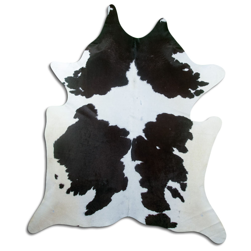 Black and white cowhide rug of about 220 × 200 cm, seen from above: the exact hide you receive