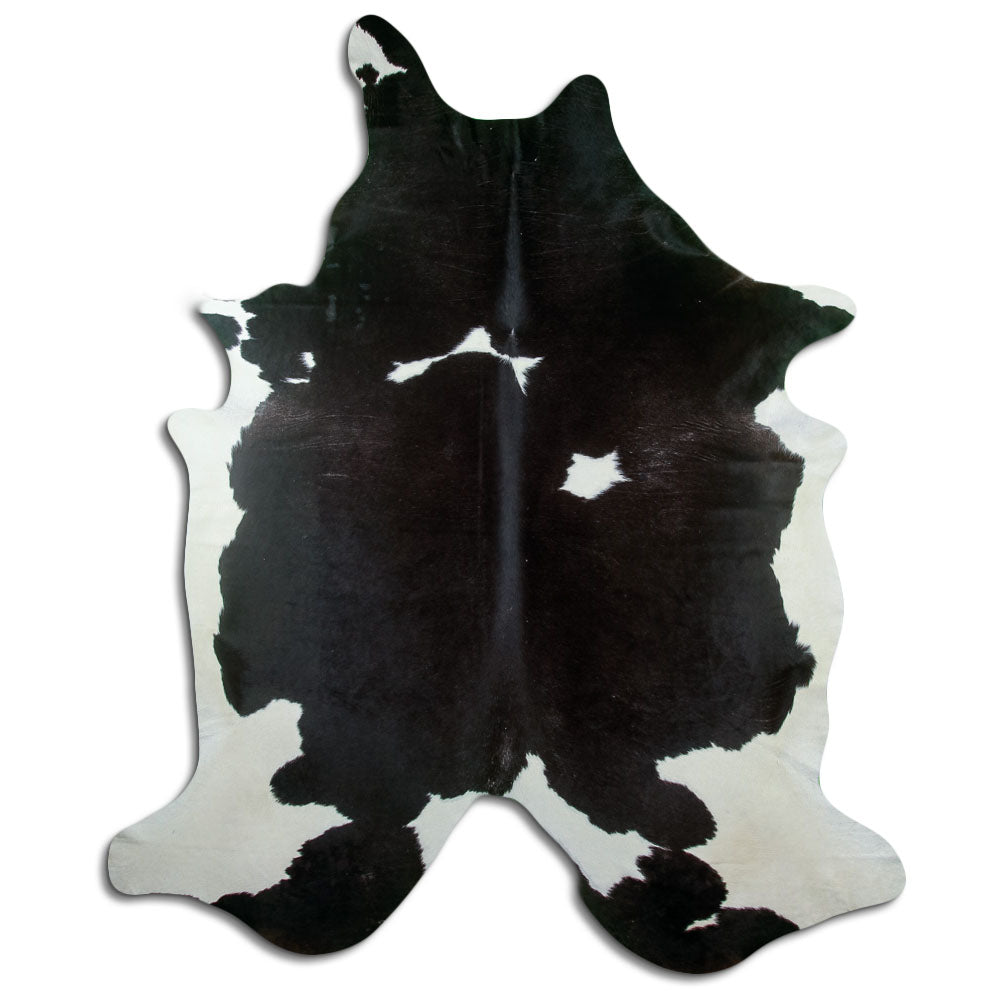 Black and white cowhide rug of about 250 × 220 cm, seen from above: the exact hide you receive