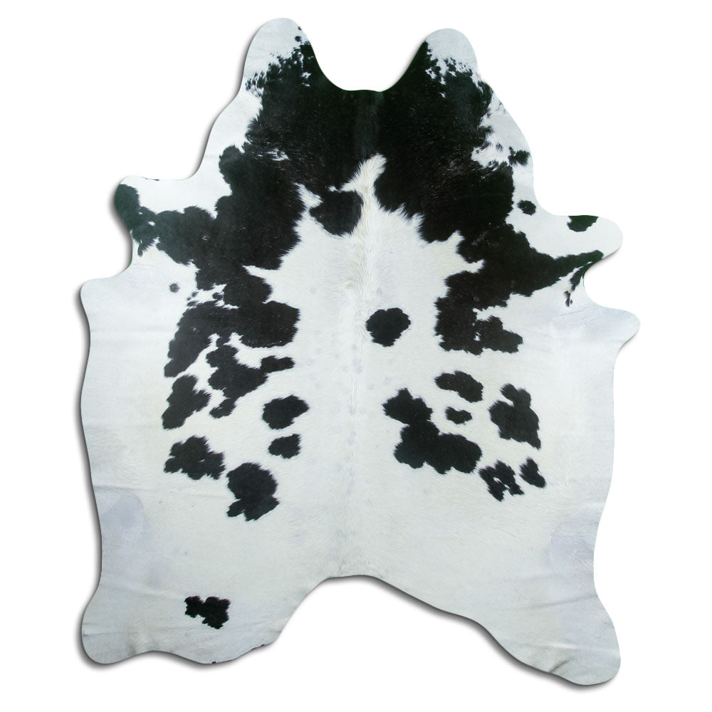 Black and white cowhide rug of about 210 × 180 cm, seen from above: the exact hide you receive