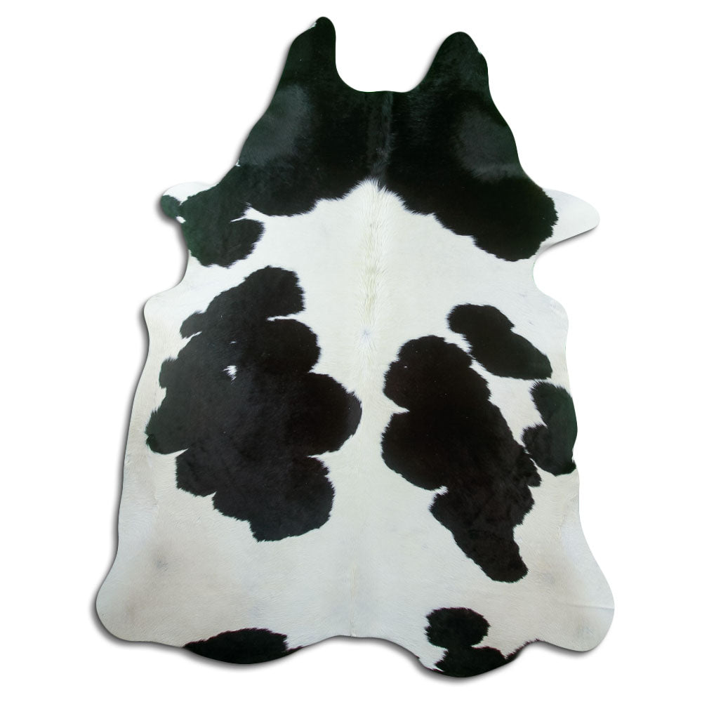Black and white cowhide rug of about 220 × 180 cm, seen from above: the exact hide you receive