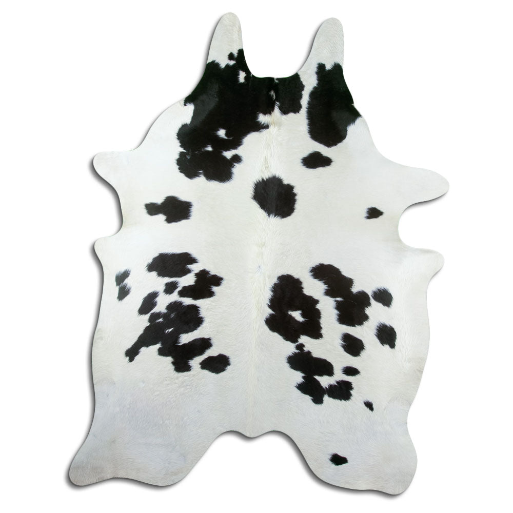 Black and white cowhide rug of about 230 × 170 cm, seen from above: the exact hide you receive