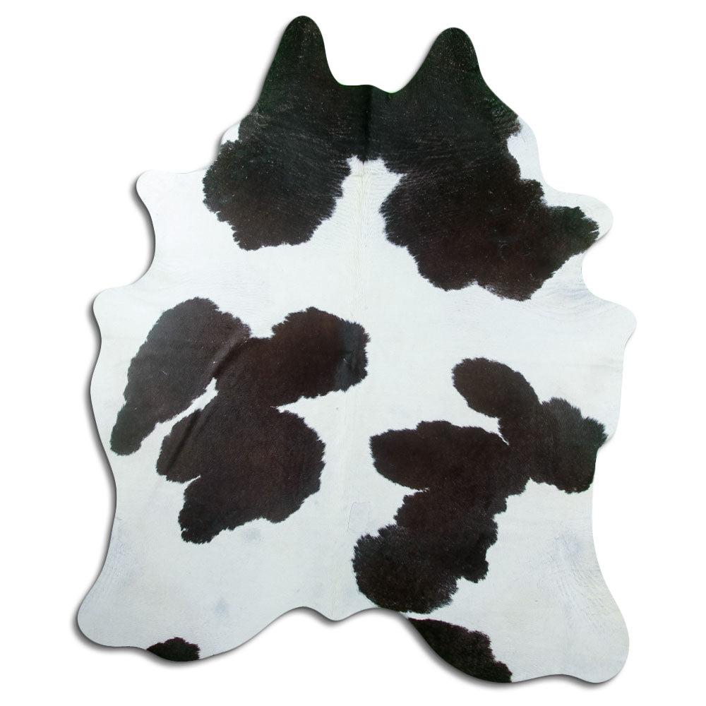 Black and white cowhide rug of about 210 × 180 cm, seen from above: the exact hide you receive