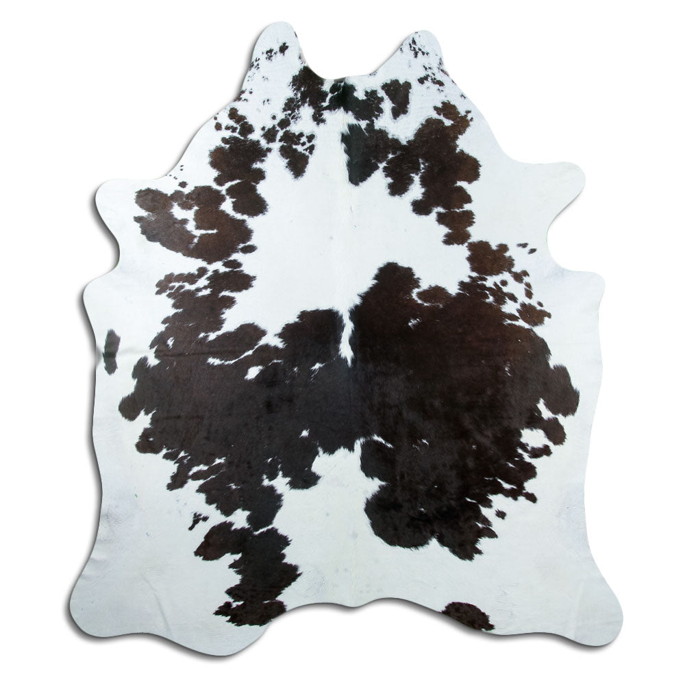 Black and white cowhide rug of about 220 × 200 cm, seen from above: the exact hide you receive