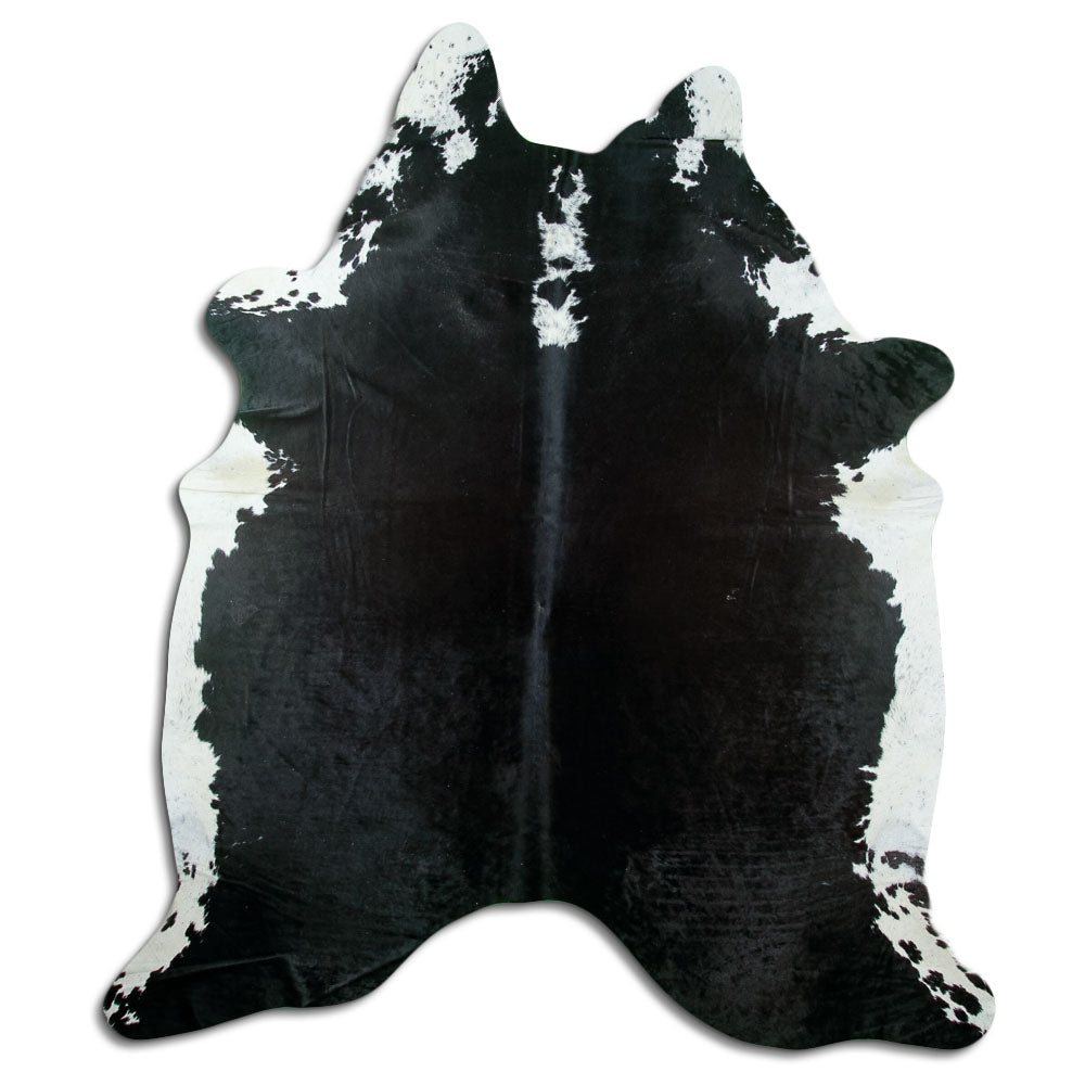 Black and white cowhide rug of about 220 × 190 cm, seen from above: the exact hide you receive