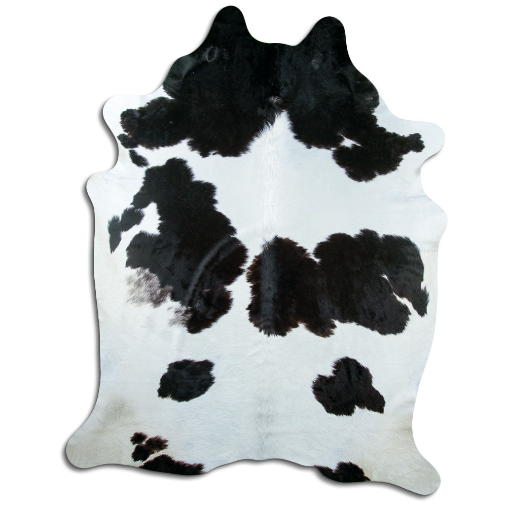Black and white cowhide rug of about 240 × 190 cm, seen from above: the exact hide you receive