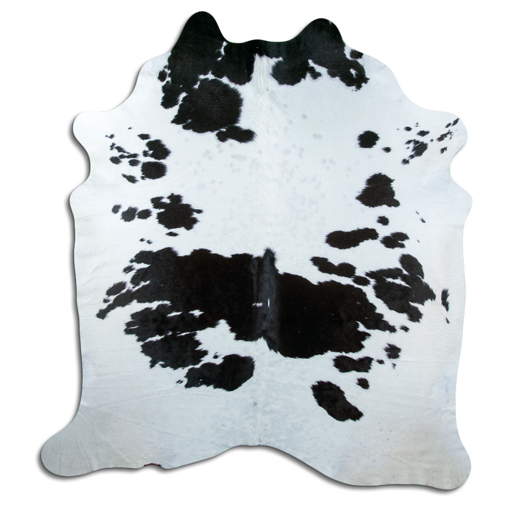 Black and white cowhide rug of about 220 × 210 cm, seen from above: the exact hide you receive