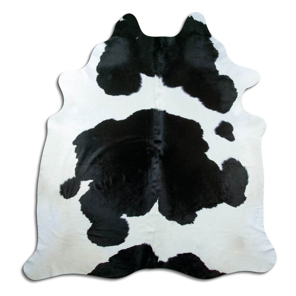Black and white cowhide rug of about 220 × 200 cm, seen from above: the exact hide you receive