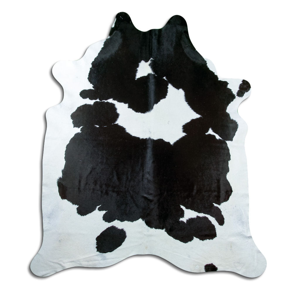 Black and white cowhide rug of about 220 × 200 cm, seen from above: the exact hide you receive