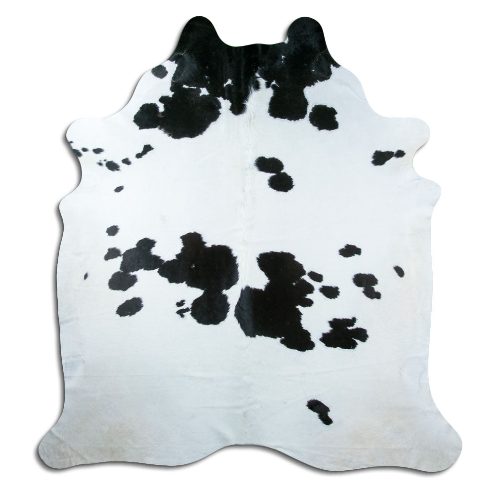 Black and white cowhide rug of about 220 × 210 cm, seen from above: the exact hide you receive