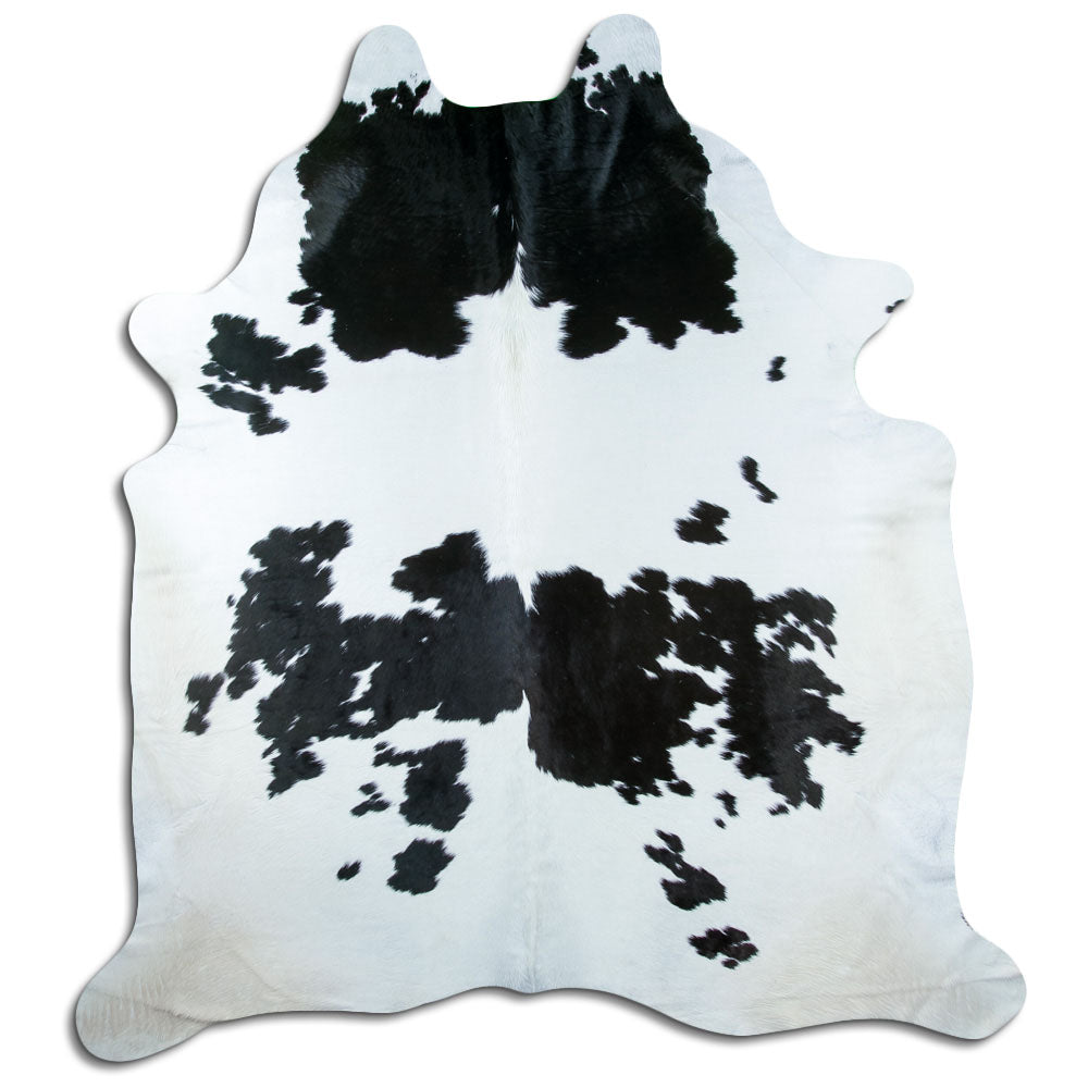 Black and white cowhide rug of about 240 × 210 cm, seen from above: the exact hide you receive