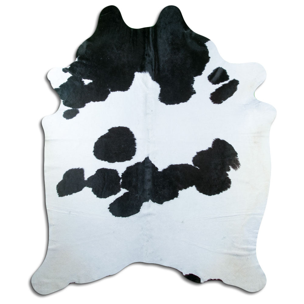 Black and white cowhide rug of about 230 × 180 cm, seen from above: the exact hide you receive