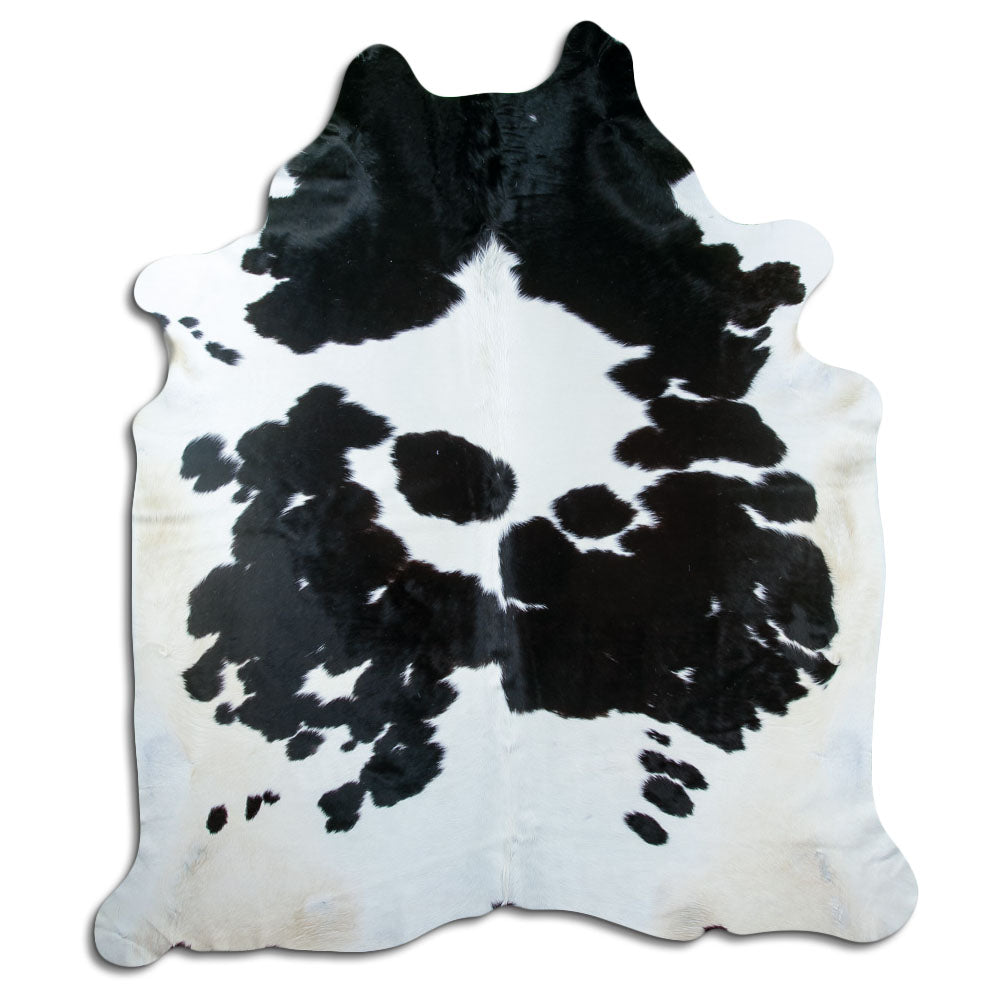 Black and white cowhide rug of about 240 × 210 cm, seen from above: the exact hide you receive