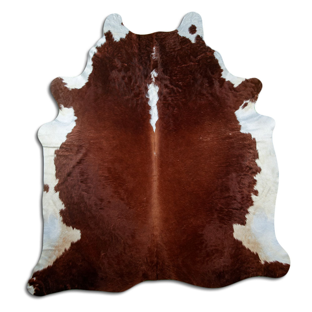 Brown and white cowhide rug of about 220 × 200 cm, seen from above: the exact hide you receive