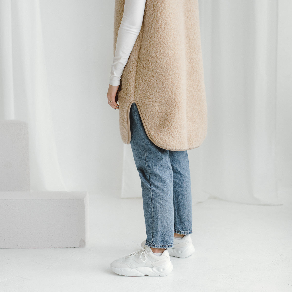 The long beige Pearl merino vest, side view