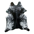 Black and white cowhide rug of about 180 × 150 cm, seen from above: the exact hide you receive