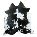 Black and white cowhide rug of about 180 × 170 cm, seen from above: the exact hide you receive
