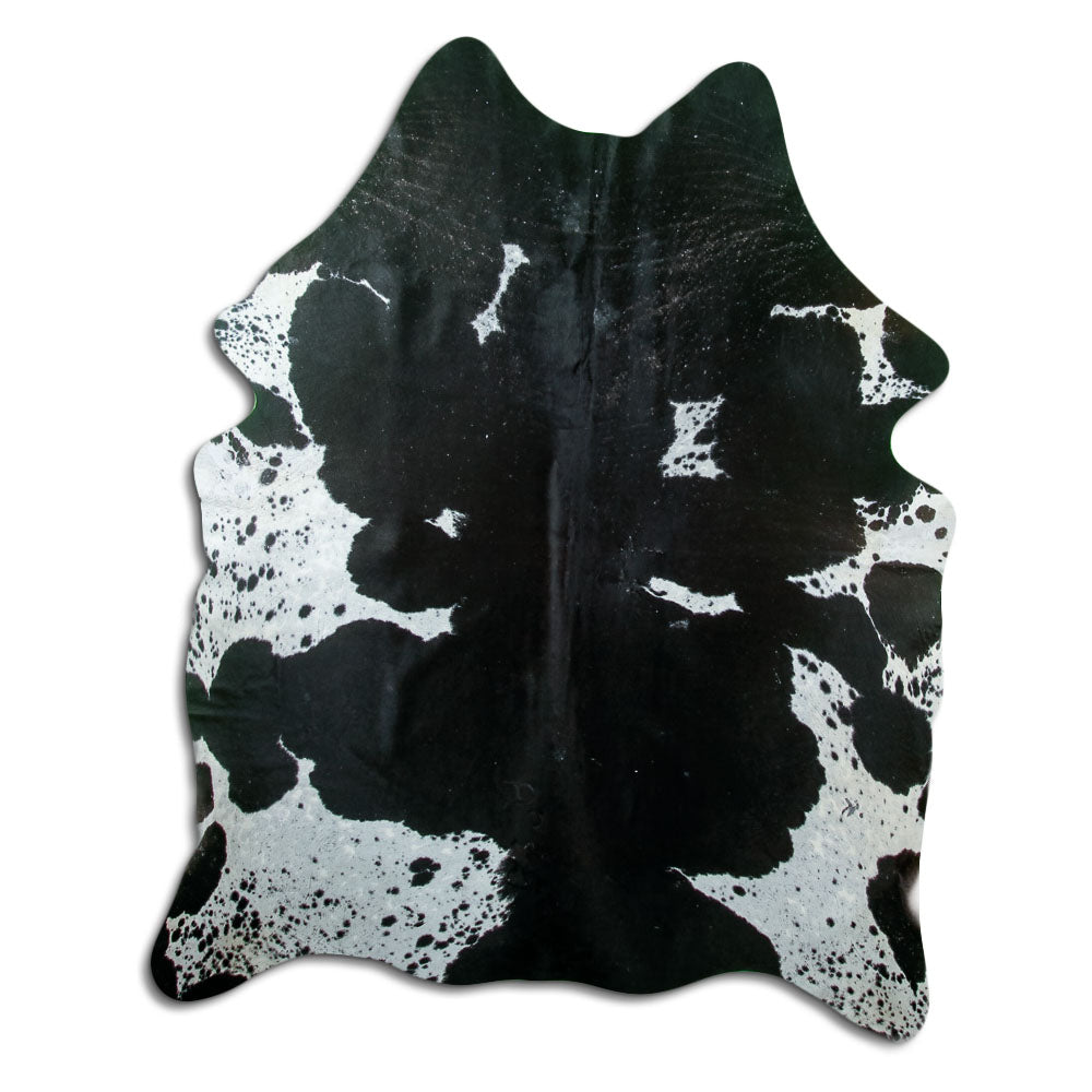 Black and white cowhide rug of about 190 × 150 cm, seen from above: the exact hide you receive