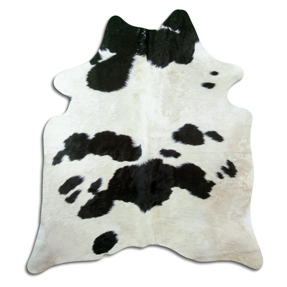 Black and white cowhide rug of about 180 × 160 cm, seen from above: the exact hide you receive