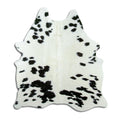 Black and white cowhide rug of about 160 × 150 cm, seen from above: the exact hide you receive