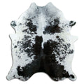 Black and white cowhide rug of about 190 × 170 cm, seen from above: the exact hide you receive