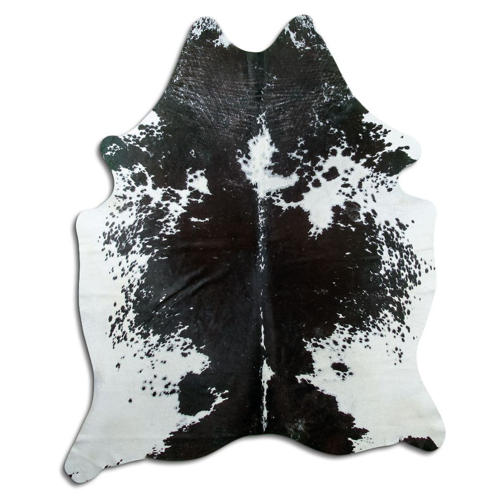 Black and white cowhide rug of about 200 × 160 cm, seen from above: the exact hide you receive