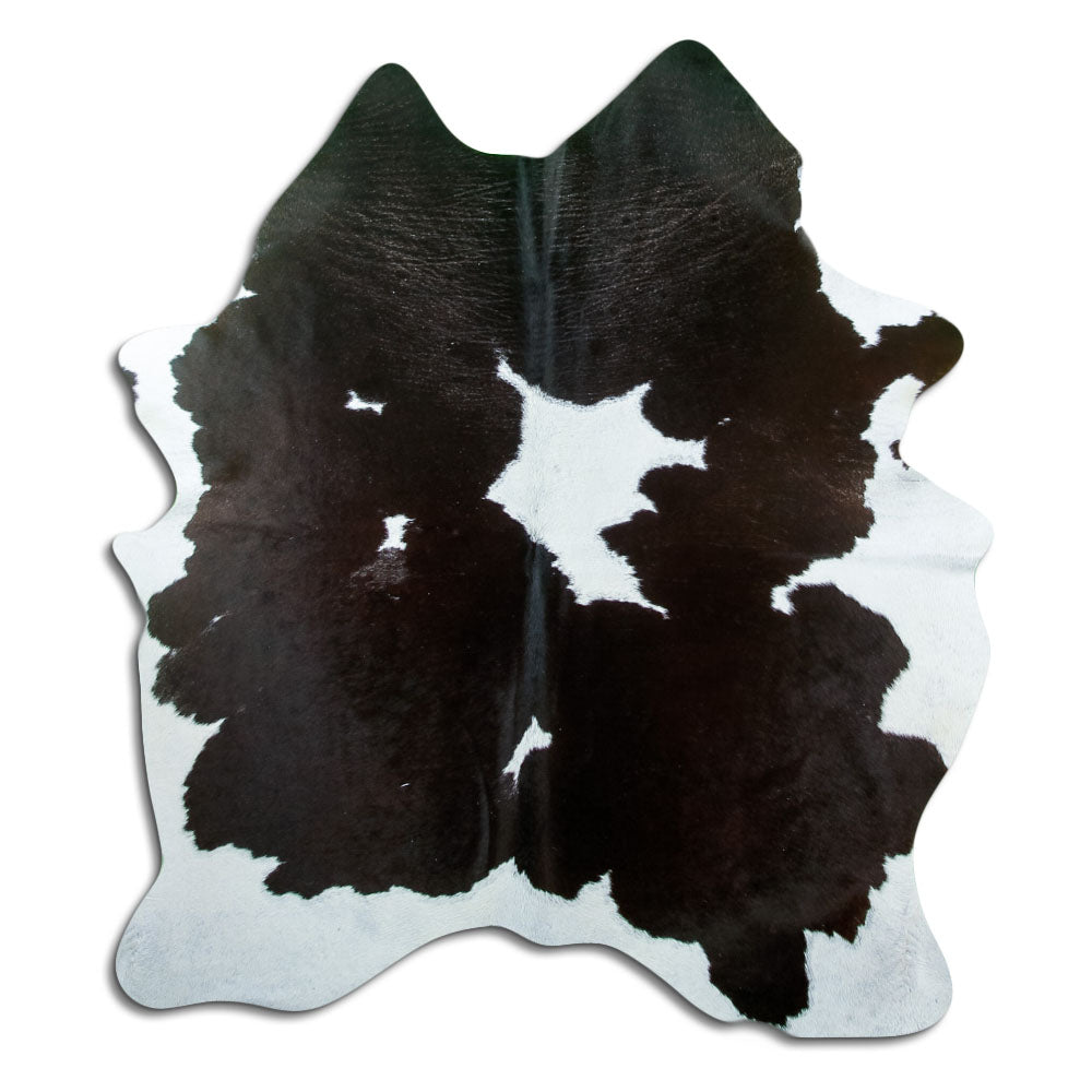 Black and white cowhide rug of about 180 × 150 cm, seen from above: the exact hide you receive