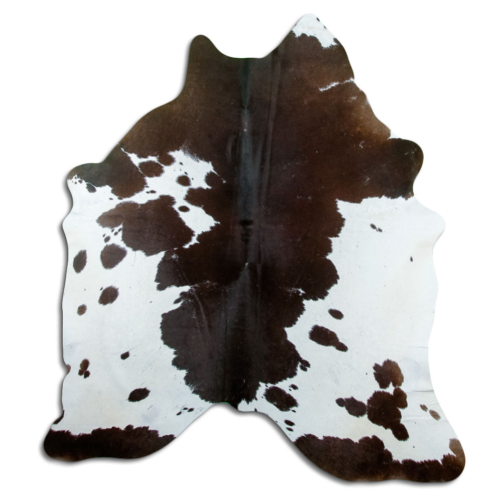 Black and white cowhide rug of about 190 × 170 cm, seen from above: the exact hide you receive