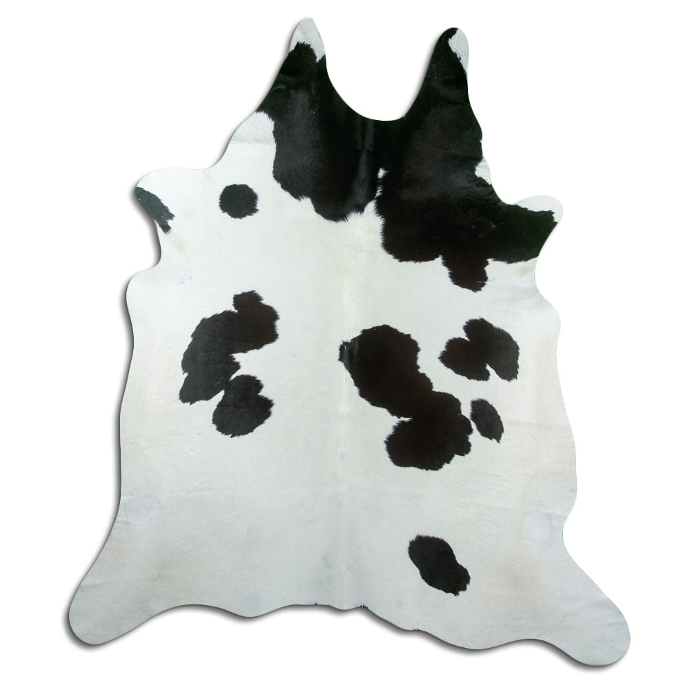 Black and white cowhide rug of about 230 × 210 cm, seen from above: the exact hide you receive