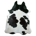 Black and white cowhide rug of about 220 × 180 cm, seen from above: the exact hide you receive