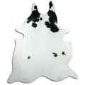 Black and white cowhide rug of about 240 × 210 cm, seen from above: the exact hide you receive