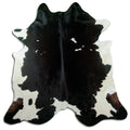 Black and white cowhide rug of about 220 × 210 cm, seen from above: the exact hide you receive