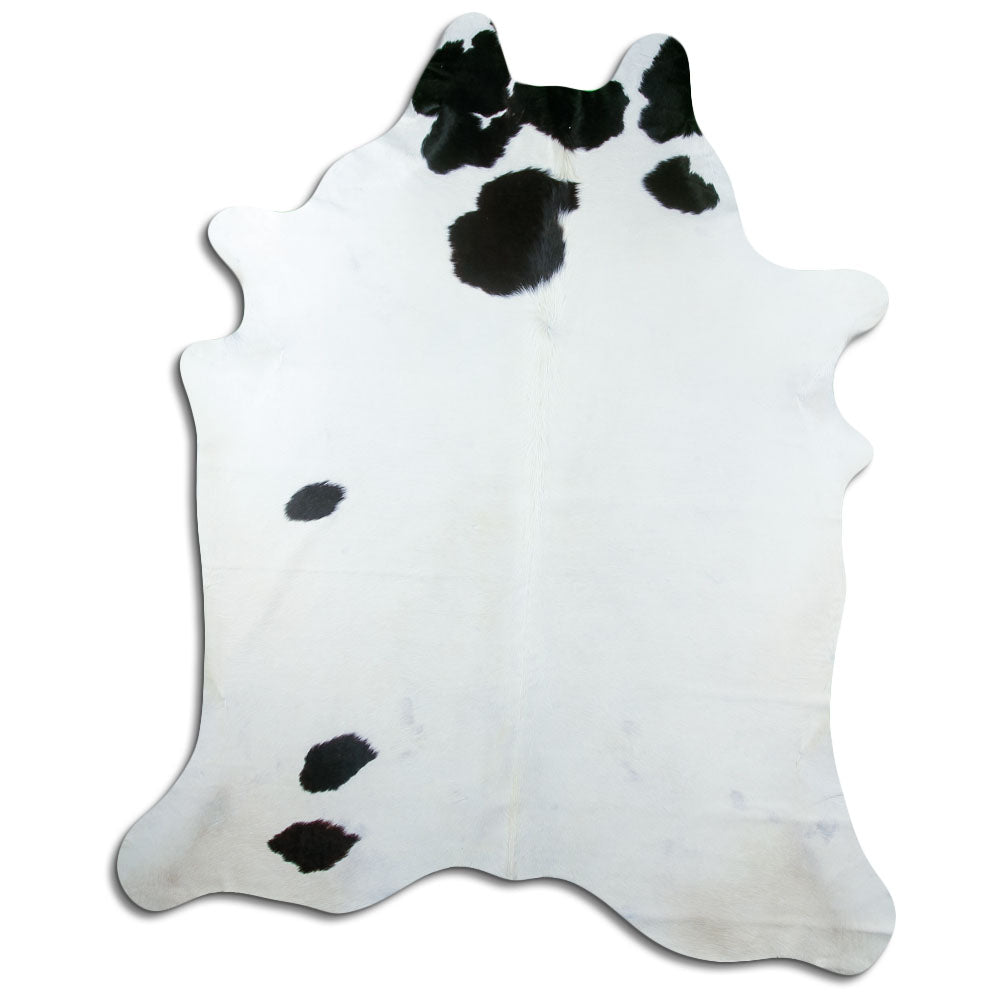 Black and white cowhide rug of about 230 × 190 cm, seen from above: the exact hide you receive