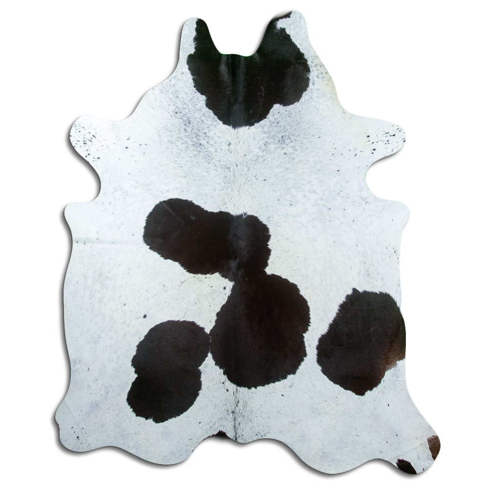 Black and white cowhide rug of about 220 × 180 cm, seen from above: the exact hide you receive