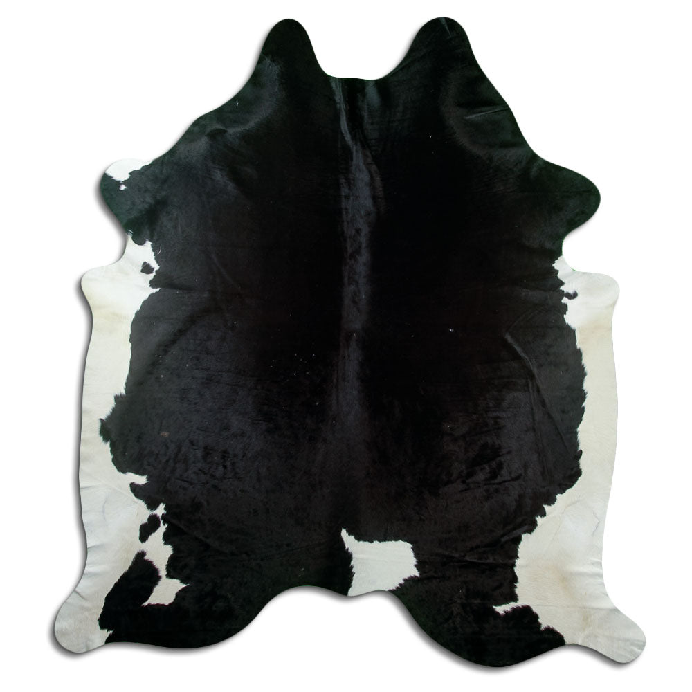 Black and white cowhide rug of about 230 × 210 cm, seen from above: the exact hide you receive