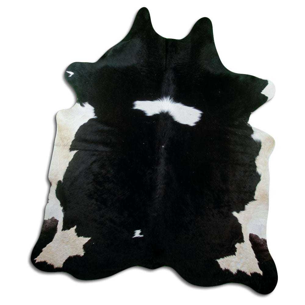 Black and white cowhide rug of about 220 × 200 cm, seen from above: the exact hide you receive