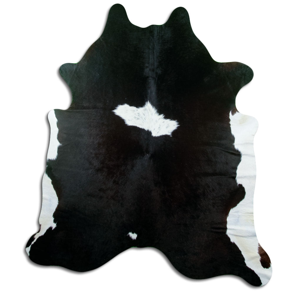 Black and white cowhide rug of about 210 × 180 cm, seen from above: the exact hide you receive