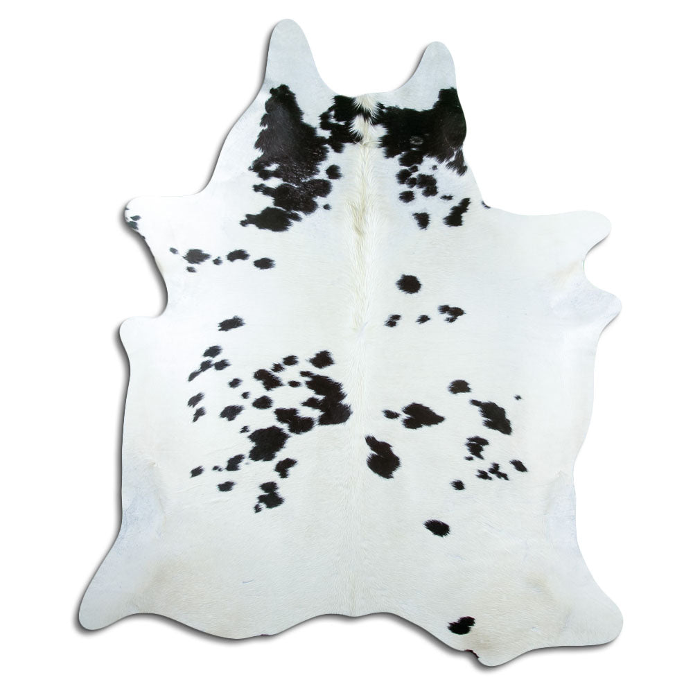 Black and white cowhide rug of about 220 × 190 cm, seen from above: the exact hide you receive