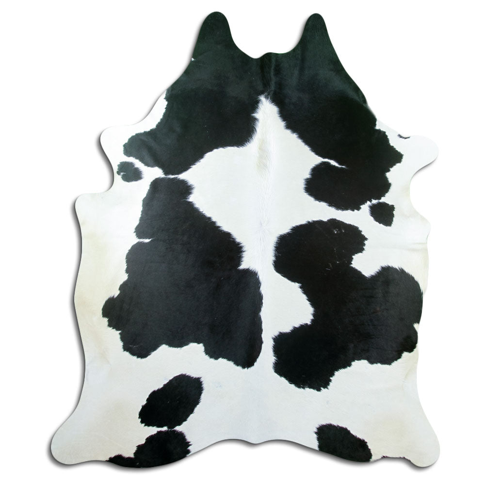Black and white cowhide rug of about 220 × 190 cm, seen from above: the exact hide you receive