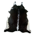 Black and white cowhide rug of about 220 × 190 cm, seen from above: the exact hide you receive