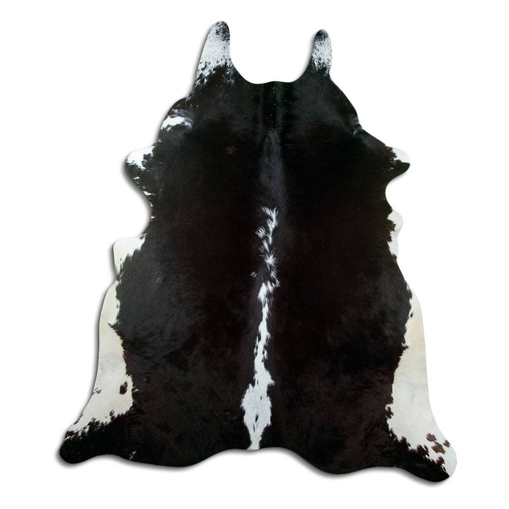 Black and white cowhide rug of about 220 × 190 cm, seen from above: the exact hide you receive