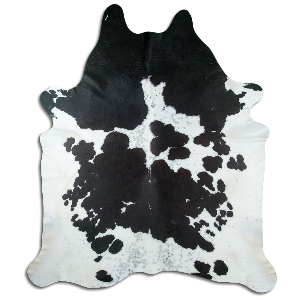 Black and white cowhide rug of about 240 × 210 cm, seen from above: the exact hide you receive