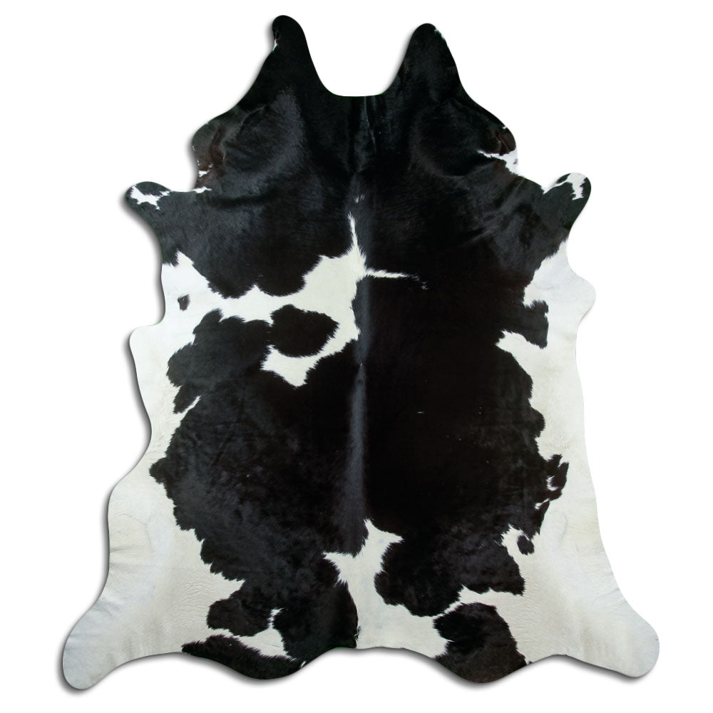 Black and white cowhide rug of about 250 × 220 cm, seen from above: the exact hide you receive