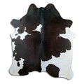 Black and white cowhide rug of about 200 × 180 cm, seen from above: the exact hide you receive