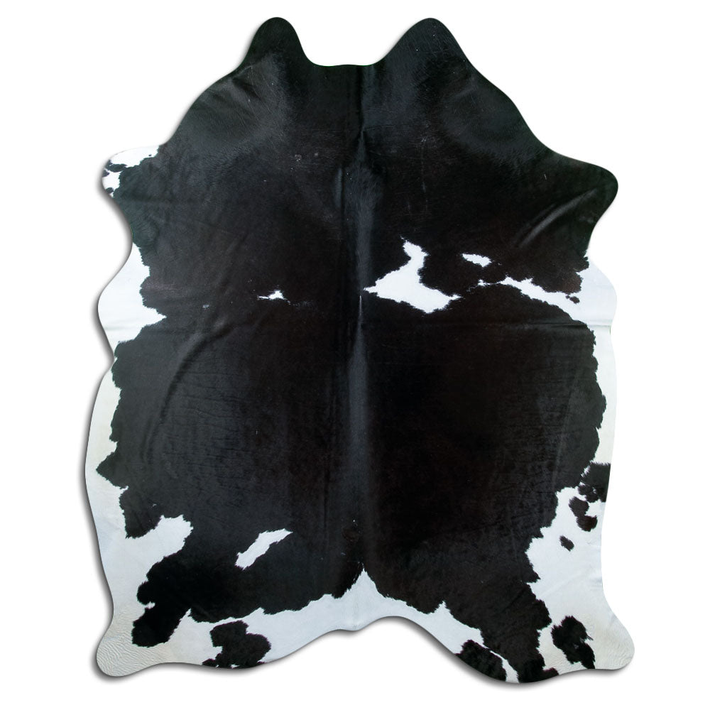 Black and white cowhide rug of about 230 × 180 cm, seen from above: the exact hide you receive