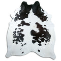 Black and white cowhide rug of about 230 × 200 cm, seen from above: the exact hide you receive