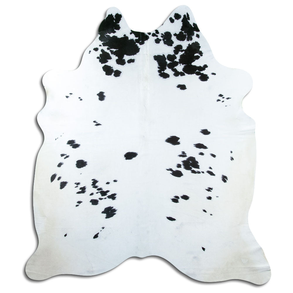 Black and white cowhide rug of about 220 × 190 cm, seen from above: the exact hide you receive