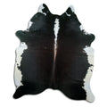 Black and white cowhide rug of about 210 × 180 cm, seen from above: the exact hide you receive